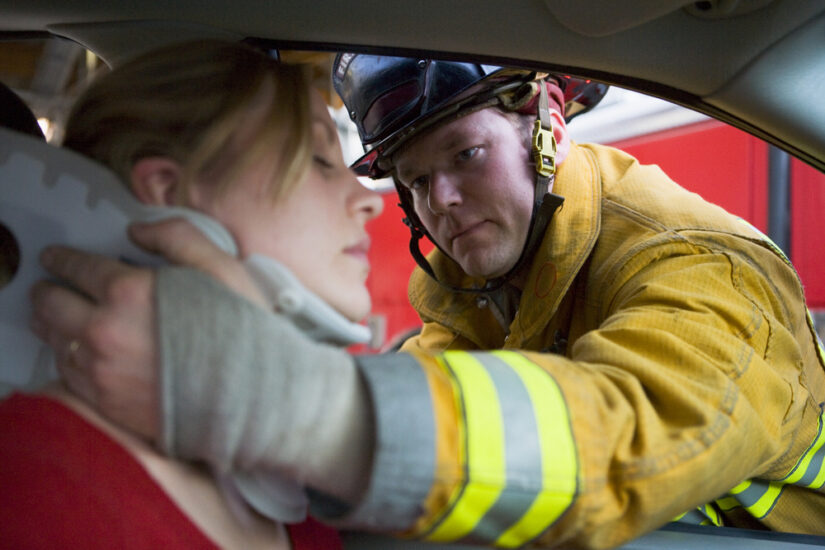 Photo of a Firefighter Helping an Injured Woman in a Car